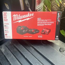 Milwaukee batteries, two batteries and a charger