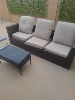 Patio set with new pillows and two chairs