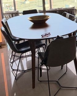 west elm mid century ext. table and 4 leather chairs