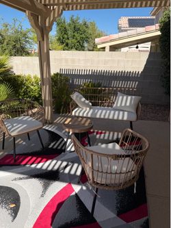 Outdoors, couch and table and two chairs