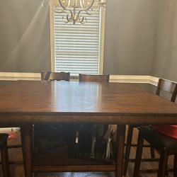 Brown Table With 8 Chairs And Storage Space Underneath