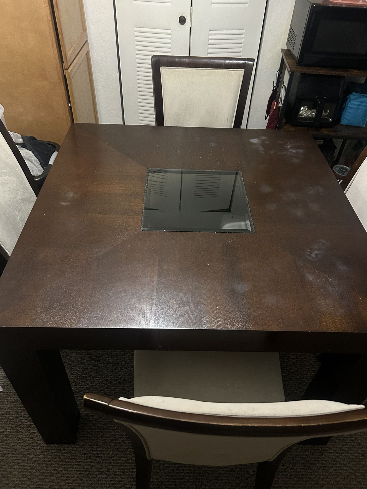 Wooden dining room table with four chairs