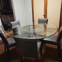 Round glass dining table. 5 chairs 