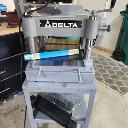 Delta Invicta 13 inch planer with extra blades and mobile base.