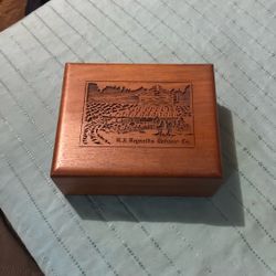  vintage wood storage box featuring laser engraving, likely produced by the Lasercraft