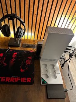 Xbox with red wireless remote and sea gate external hard drives