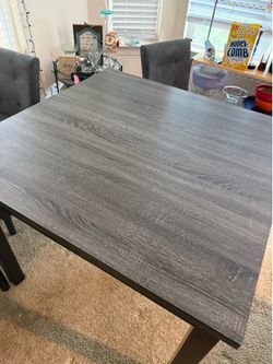 Ashley furniture table high table set. Dark wood grey four chairs.