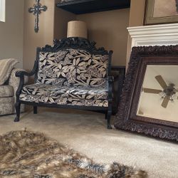 Antique love seat with leopards on the wood