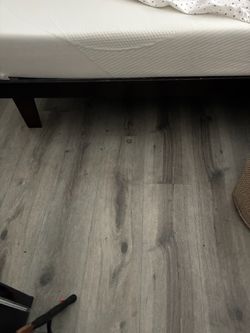 Dark brown platform bed and mattress