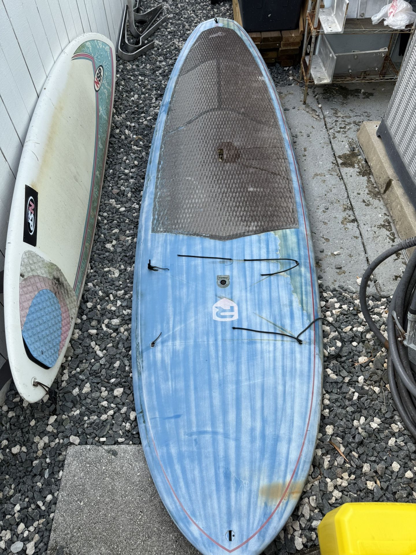 Surfboard And Paddle Board With Storage Brackets To Store