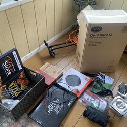 Unopened Ooni 12in multi-fuel pizza oven with cart and lots of amenities