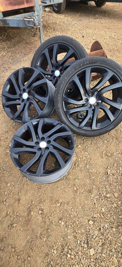 20-inch matte black Land Rover OEM alloy wheel wrapped in a Pirelli Scorpion Zero tire.
