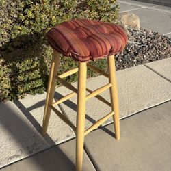 This is a wooden bar stool with a Klear Vu Omega tufted barstool cushion. 