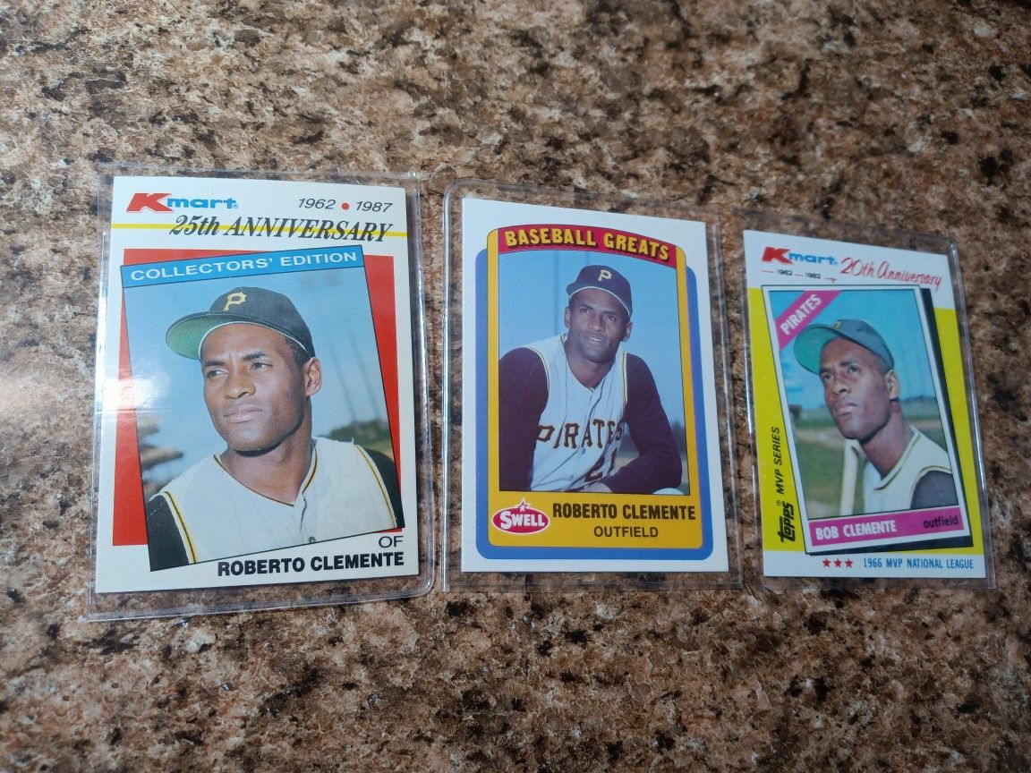 Three Roberto Clemente Baseball Cards.