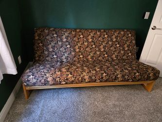 Futon - wood frame.  Mattress included