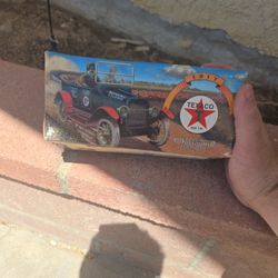 replica of a vintage 1917 Maxwell automobile, decorated with Texaco branding. 