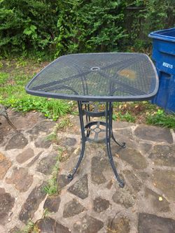 Wrought iron pub style table with umbrella hole 28 inch wide