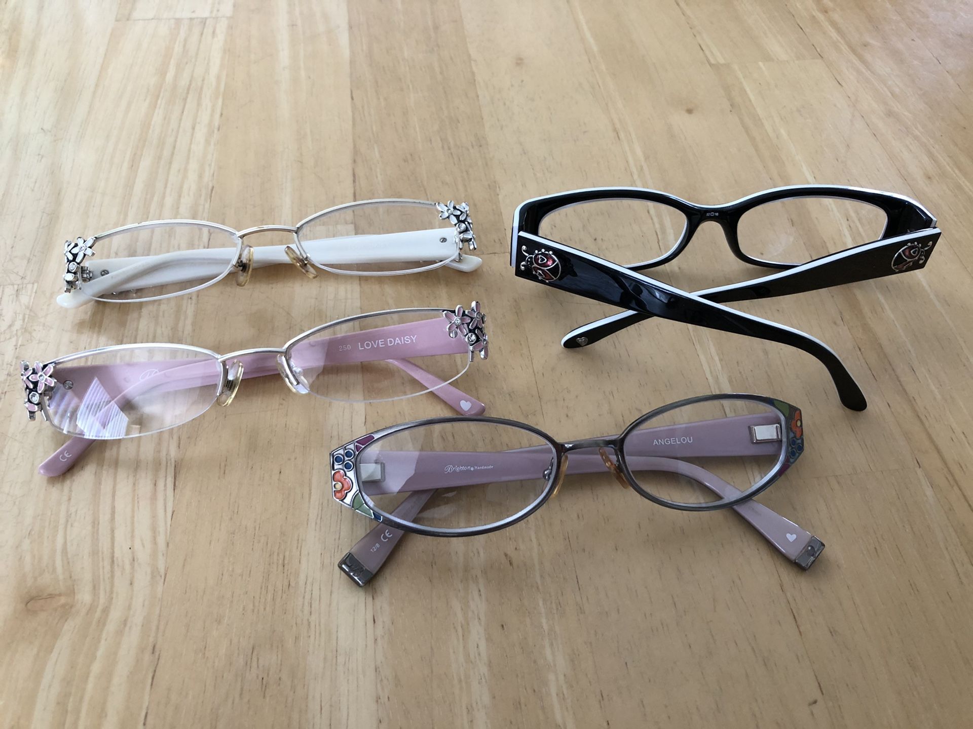 4 pairs of Brighton reading glasses. +2.5 strength. White Love Daisy; Pink Love Daisy; Black Lucky Lady; Angelou flowers. Will sell as a set or indiv