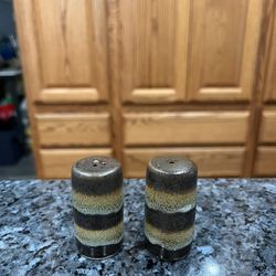 Ceramic Pair of Salt and Pepper shakers. Size approximately 2 1/2 inches tall. Brand new never used. Has been on display in a cabinet with a very l