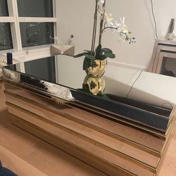 Mirrored coffee table with gold trim