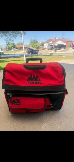Mac Tools rolling tool bag features extendable handles and heavy-duty wheels for easy transport.
