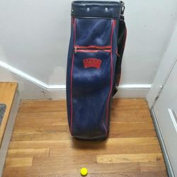 Blue And Red Golf Bag With 3 Tees And A Yellow Pinnacle Golf Ball