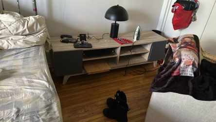 Long tan desk with 4 shelves for entertainment purposes.  Two sections with doors one on each side.