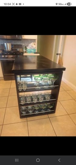 Black wood bar table with stools and glasses