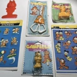 Garfield Lot Of 6 Scissors, Eraser, Pencil Sharpener Stickers And More  Items from 70’s. They are new but packaging shows wear. 5 of the items are in 