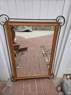 Mirror with decorative metalwork accents