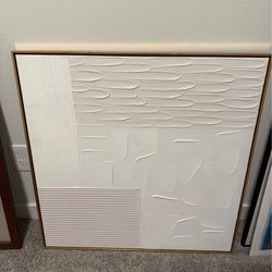 Pink and white art piece with gold frame