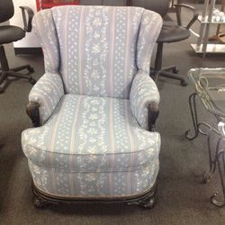 Blue vintage reception chair with wood trim and brass studs
