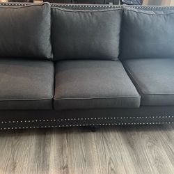 Gray studded couch