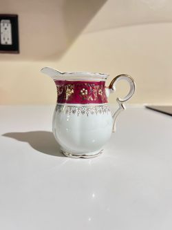 Red and gold tea cup with plate