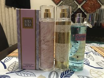 Assortment of body sprays and a perfume