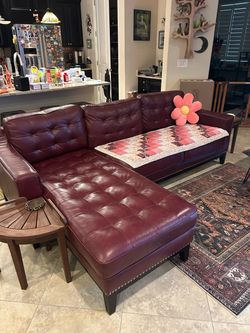 Genuine leather burgundy long couch with chaise lounger.