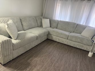 Luxury high-quality three-piece sectional light grey soft, fluffy couch
