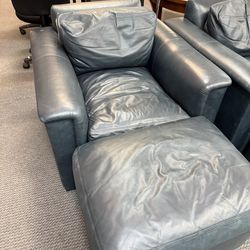 Navy leather chairs with ottomans