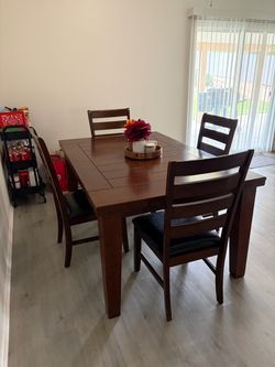 Brown Wooden dining table with 4 chairs