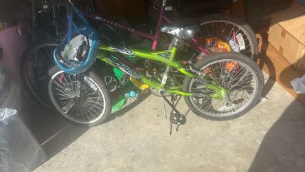 FS 20 green bike with helmet and ride on rods.