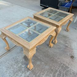 pair of carved wood and glass top occasional tables.
