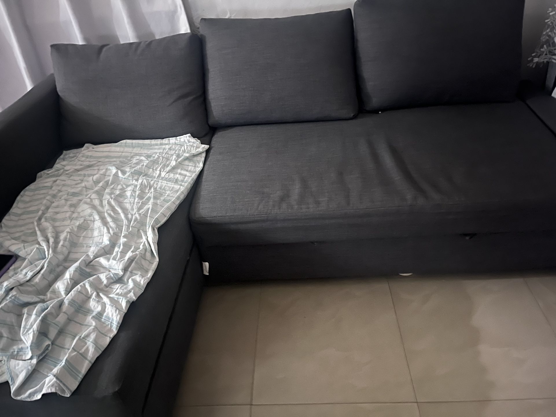 IKEA gray couch with pull out bed and storage