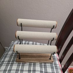 Gold and burlap bracelet display.