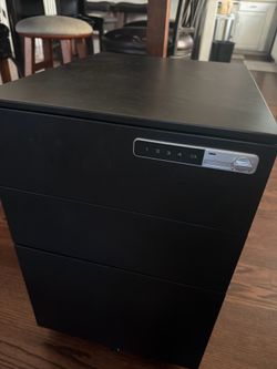 Filing cabinet with pad code touch screen lock.