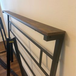 Modern bedframe with headboard. Black metal and wooden. Queen bed frame with headboard. Black metal with wooden accent.