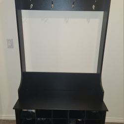 68" Hall tree with shoe storage and hangers. Black, fuax wood,  used, clean in great condition.  H 68"× W38"× D15.5"
