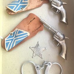 Pair of Vintage 6” Daisy Pal Toy Guns with Original Holsters, Toy Badge, and Toy Handcuffs