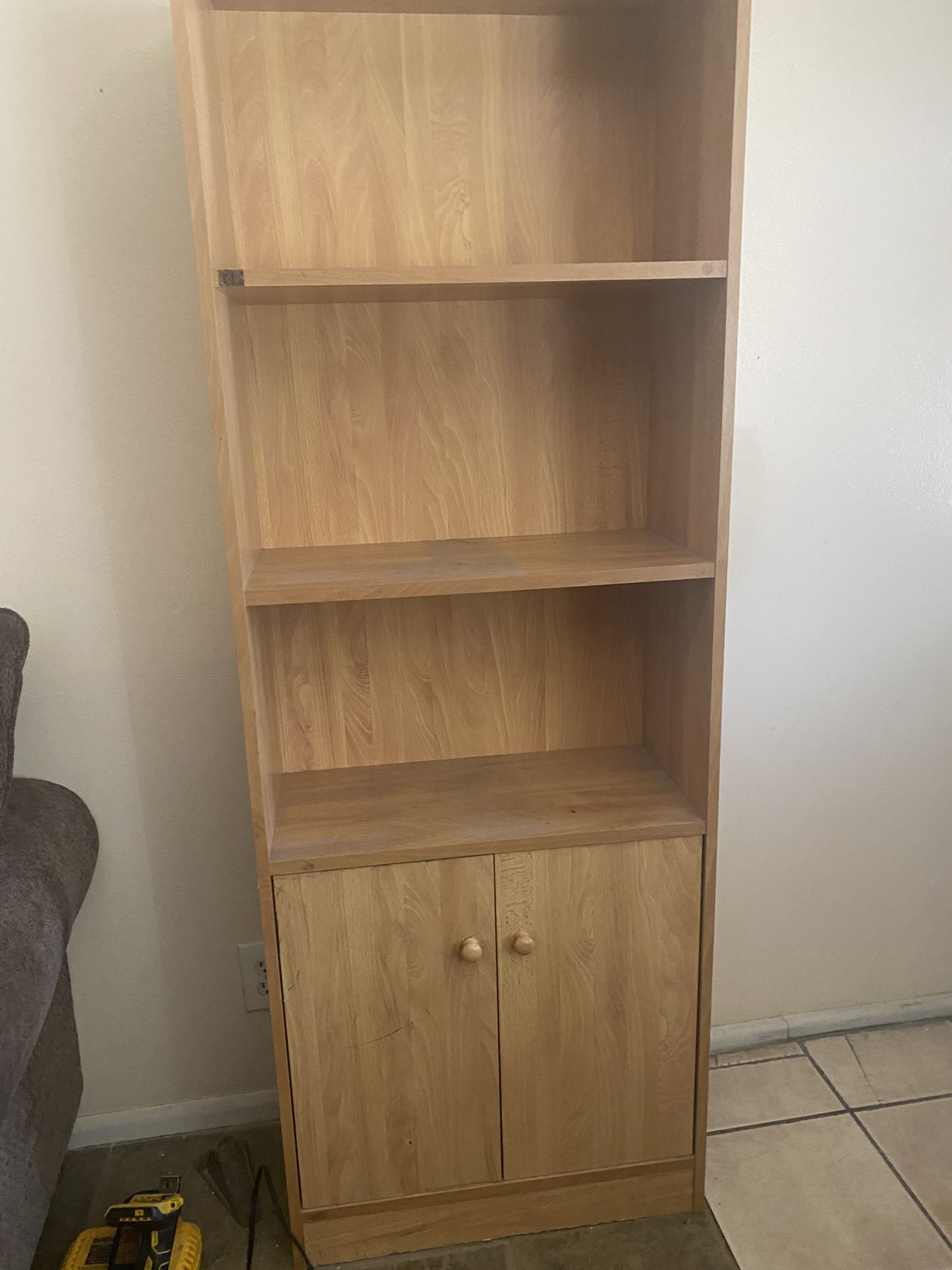 A Light Brown Shelf with Cabinets On The Bottom