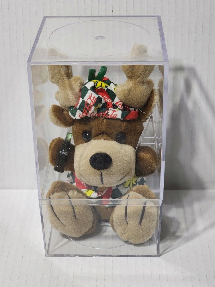 Reindeer with a COCA-COLA in Vest and Beanie The original Coca-Cola® brand