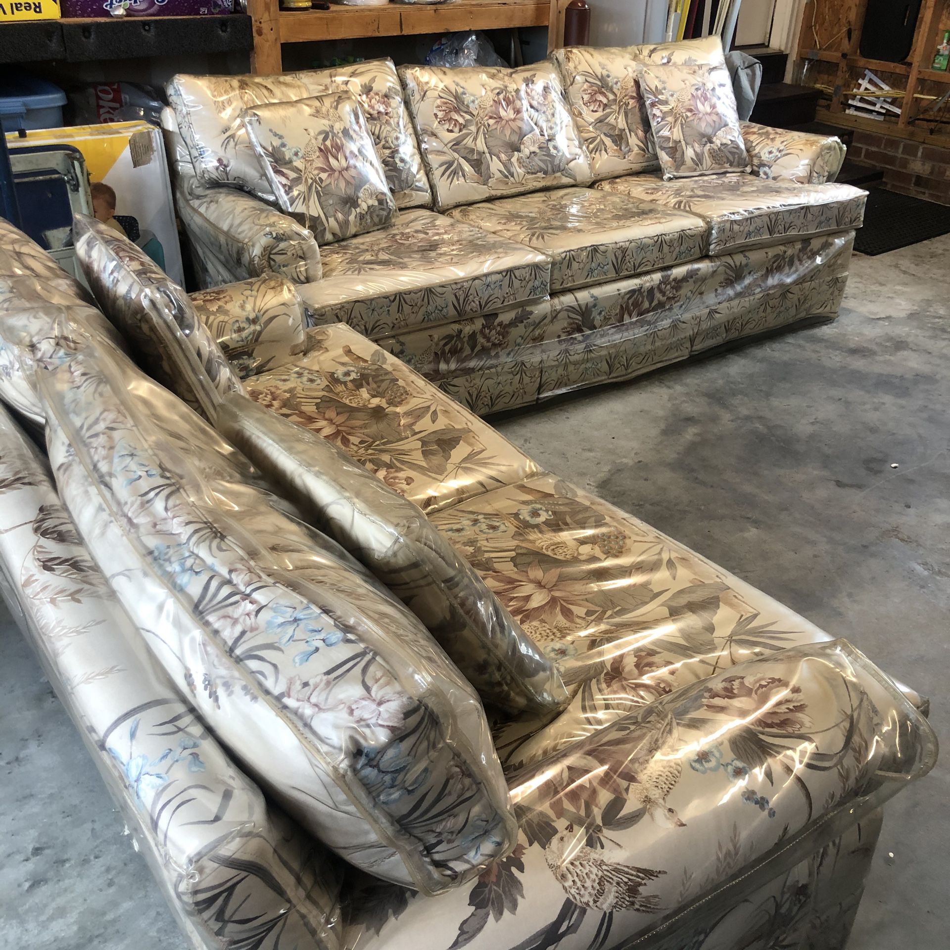 Couch and love seat protected by plastic covering